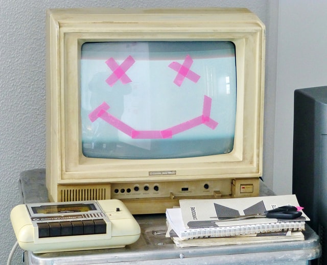 Replace this old Commodore 1802 computer with a smiley face with X's for eyes on the screen made with pink tape as part of your Summer school IT projects